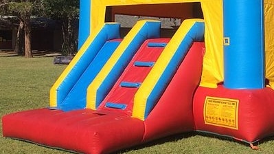 A colourful bouncy castle on a lawn