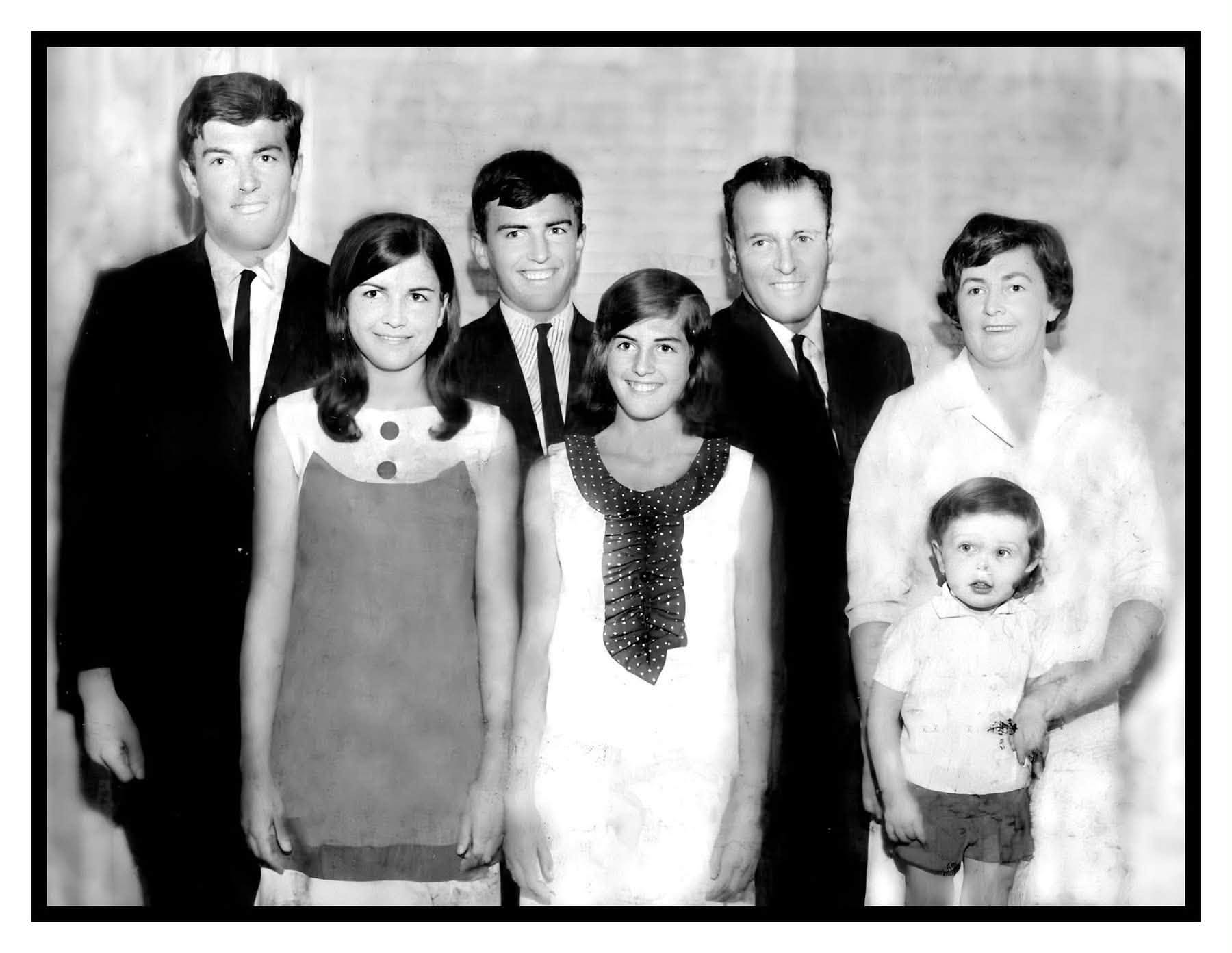 A black and white family photo featuring seven people.