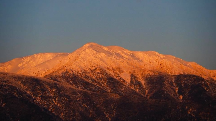 Snow covered mountain at sunset.