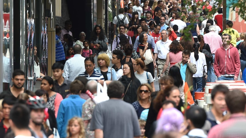 A crowd pulses through the city