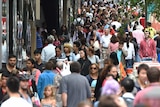 A crowd pulses through the city