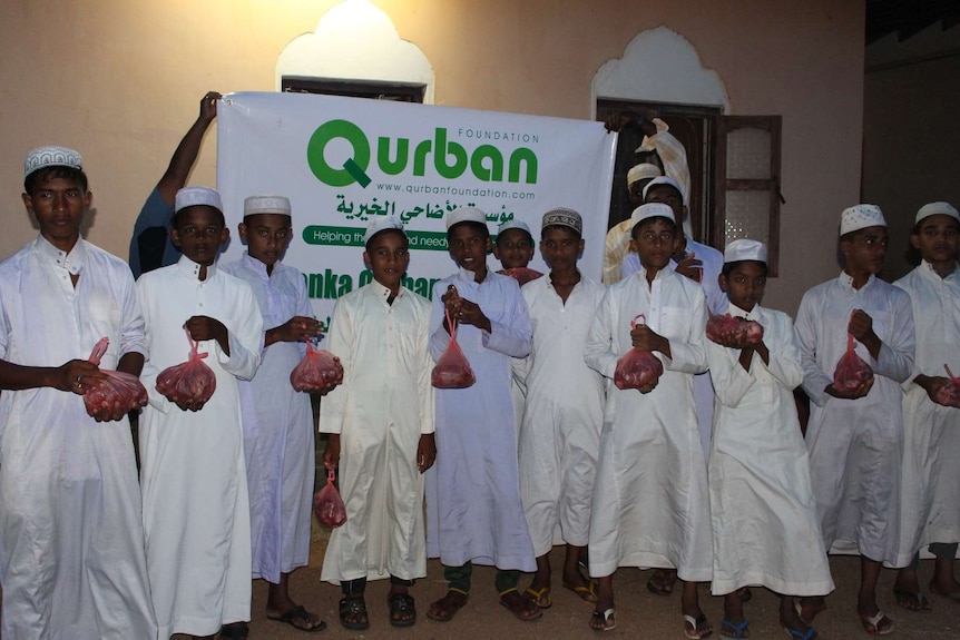 A group of boys in Sri Lanka collect donation of sacrificed meat.