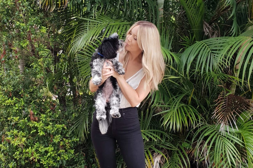 Kellie Scott holding her dog Peppa