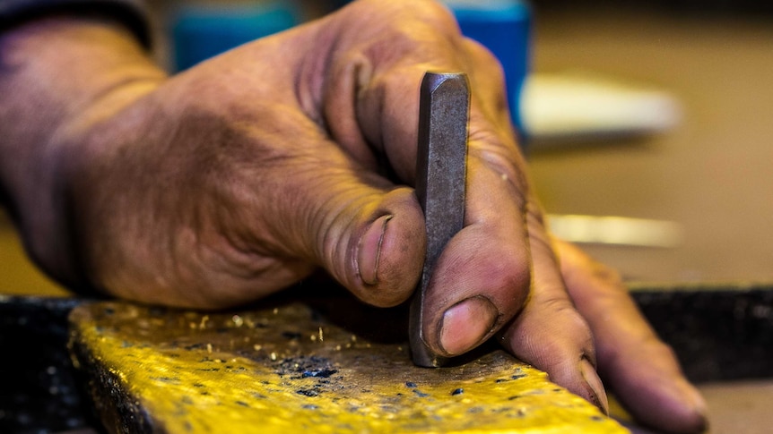 Gold bar being stamped