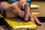 Gold bar being stamped