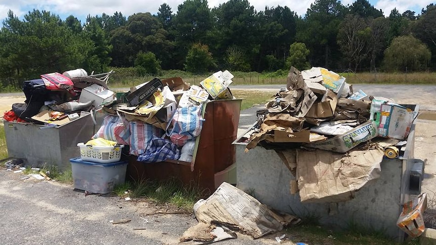 Three large bins overflowing with rubbish at the Tenterfield tip.