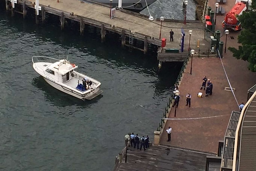 Police at the scene where a body was found floating in Sydney Harbour, near The Rocks.