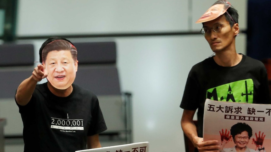 Hong Kong MPs wear masks of Chinese President Xi Jinping in parliament.
