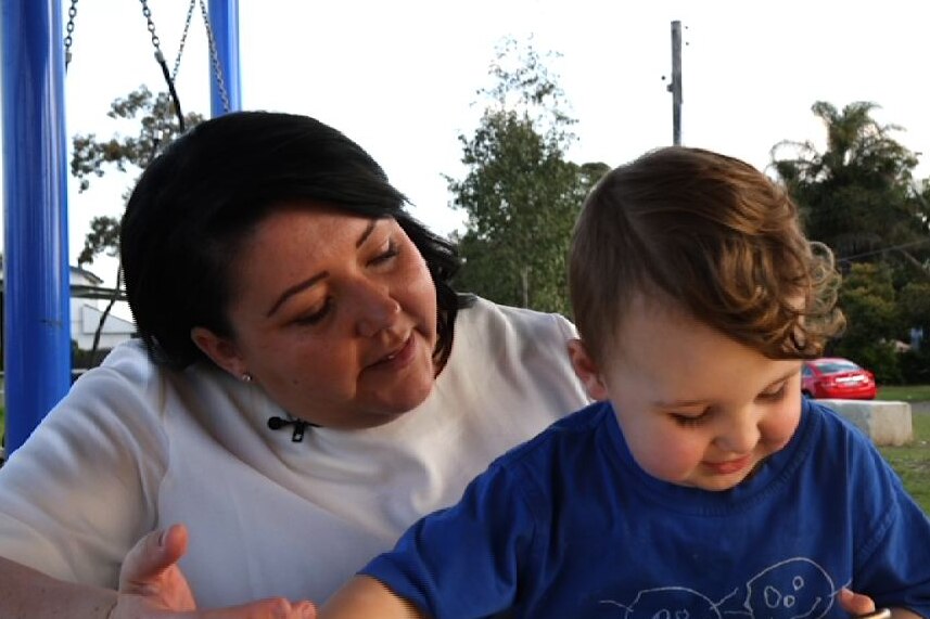 Learning Ground volunteer Cassandra Jackson and her son Ryder sit at a park table