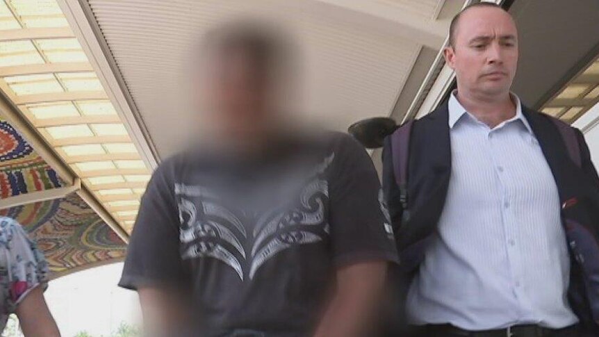 A New Zealand man (centre) being extradited to Darwin on historical sex offence charges.