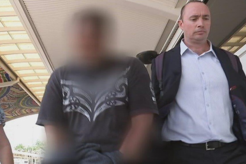 A New Zealand man (centre) being extradited to Darwin on historical sex offence charges.