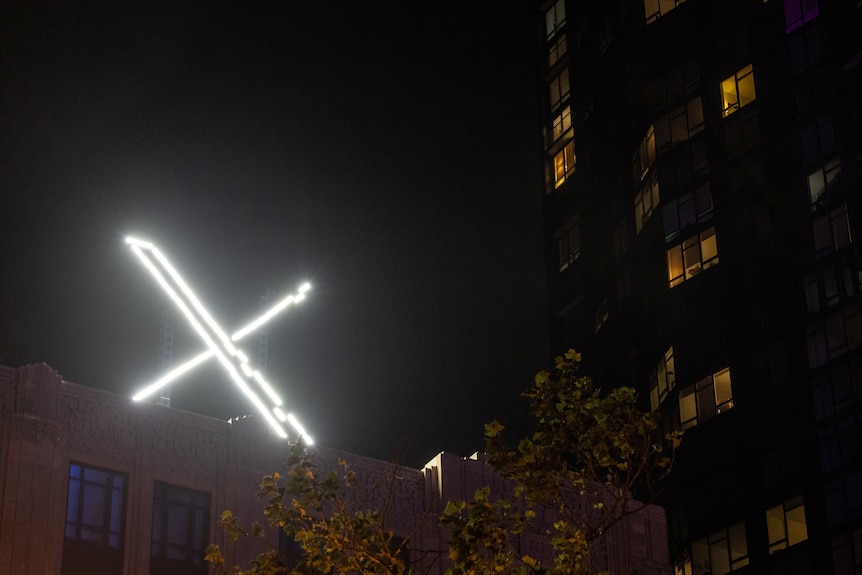 'X' logo is seen on the top of the headquarters of the messaging platform X.