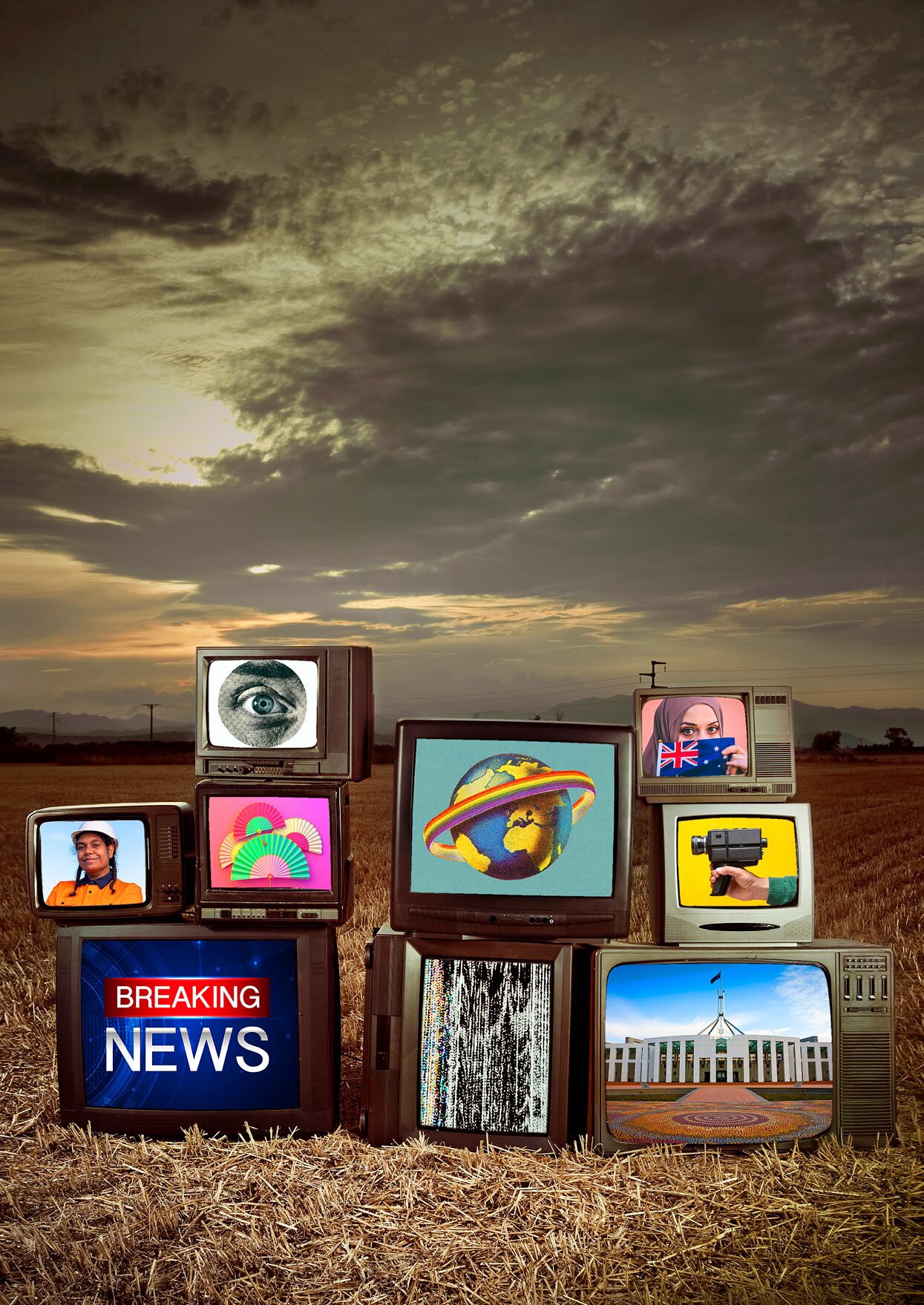 An abstract image of a pile of televisions showing different images in a field. 