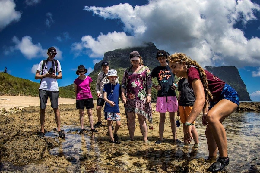 Caitlin shows visitors a rock pool