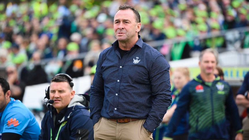Ricky Stuart stands on the sidelines with his hands in his pockets as he watches the Raiders against the Cowboys.