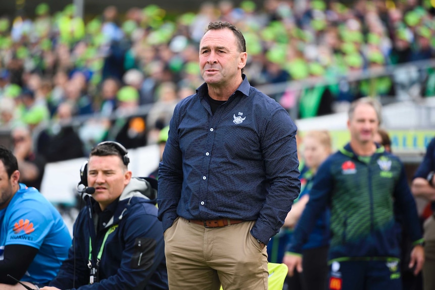 Ricky Stuart stands on the sidelines with his hands in his pockets as he watches the Raiders against the Cowboys.