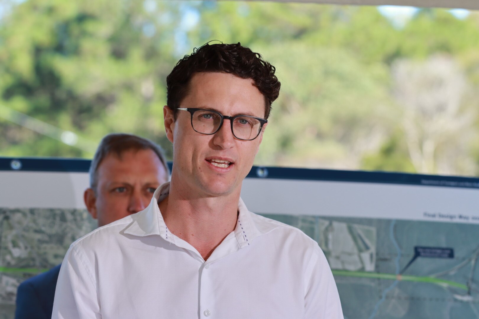 An image of a man wearing a white business shirt and glasses.