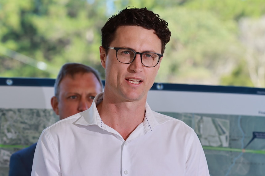 An image of a man wearing a white business shirt and glasses.