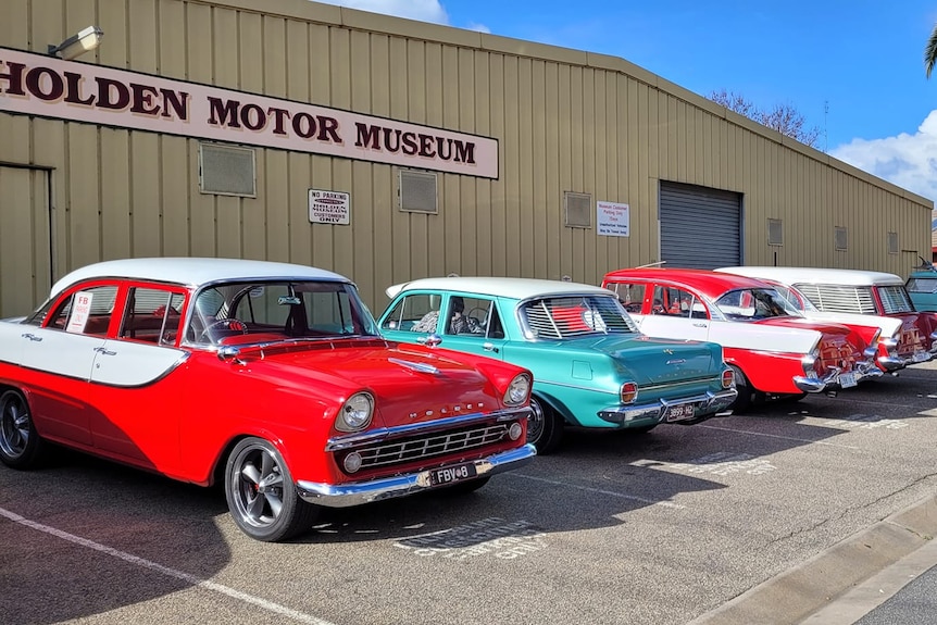 a series of holden cars outside the musuem 