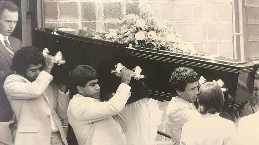 Marks dad and uncles carrying his coffin to the hearse.