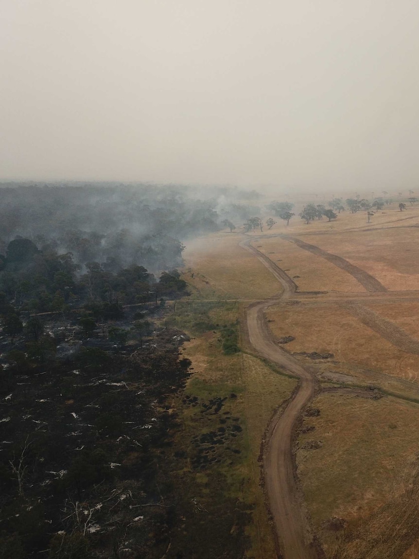 An aerial shot shows Budj Bim National Park smoking close to a house.