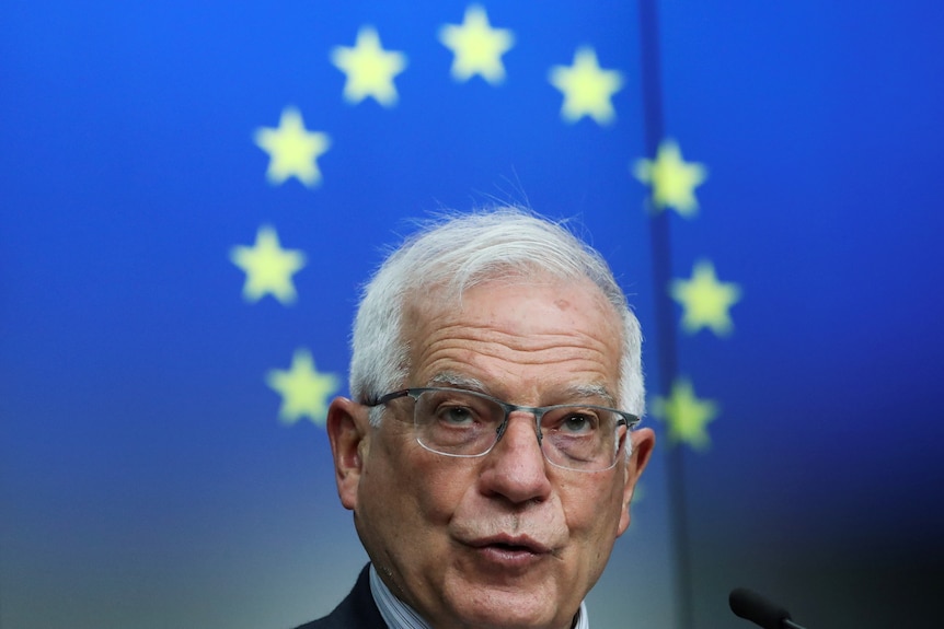 A man's head with the stars of the EU flag in the background.