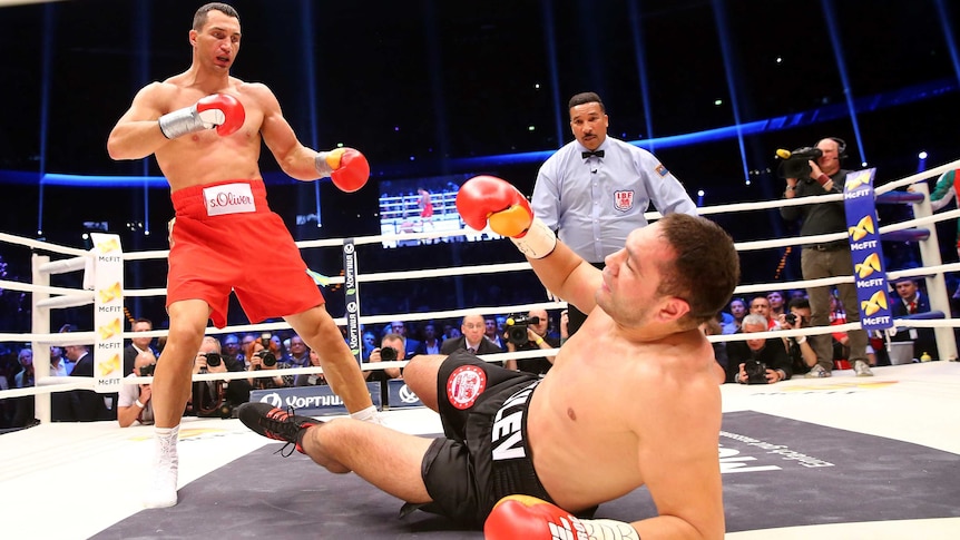 Wladimir Klitschko (L) knocks down Kubrat Pulev during their IBF heavyweight boxing title fight.