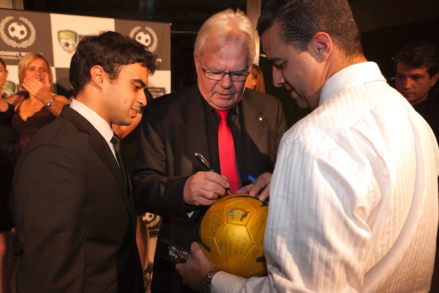 Les Murray signs a football in Sydney