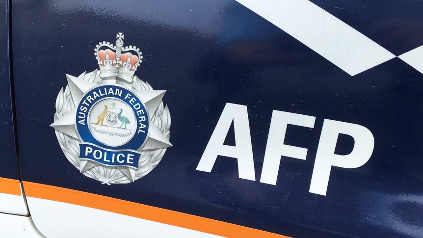 Australian Federal Police livery on car door.