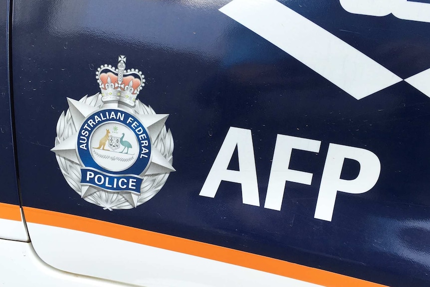 Australian Federal Police livery on car door.