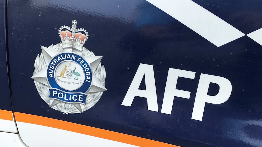 Australian Federal Police livery on car door.