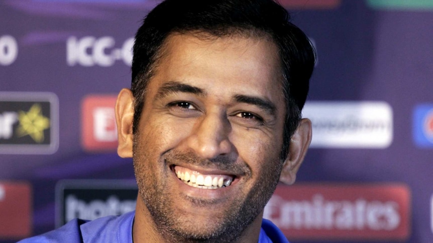 Mahendra Singh Dhoni smiles during a press conference