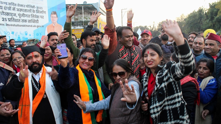 India's Bharatiya Janata Party supporters celebrate after Uttarakhand state lawmakers passed a new civil code.