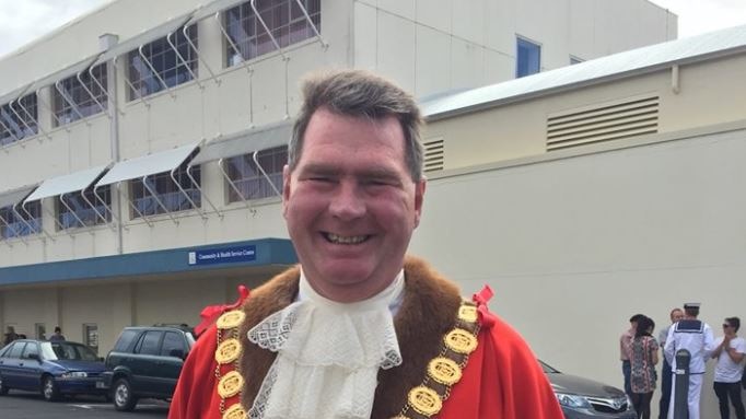 Devonport Mayor Steve Martin smiling in his official robes in a carpark