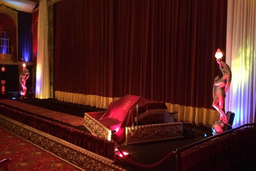 The Plaza Theatre's main auditorium, where the opening of red curtains still heralds the start of a movie screening.