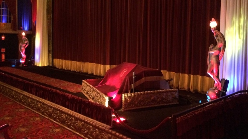 The Plaza Theatre's main auditorium, where the opening of red curtains still heralds the start of a movie screening.