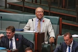 Ian Goodenough smiles from the back bench during Question Time.