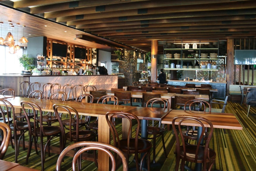 Empty tables and chairs in a restaurant.