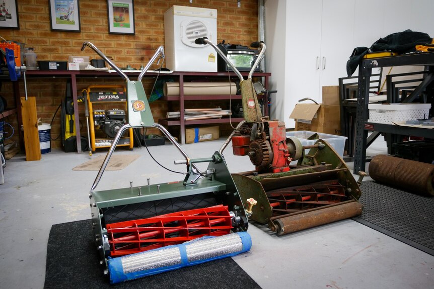 A cylinder mower that has been restored (on left) and one that is waiting to be restored (on right).