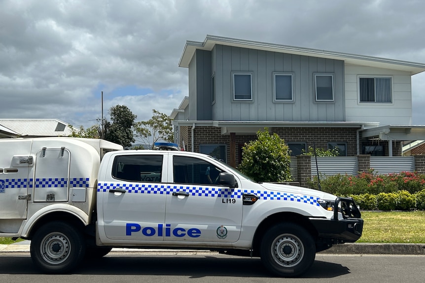 A house with a police car out the front.