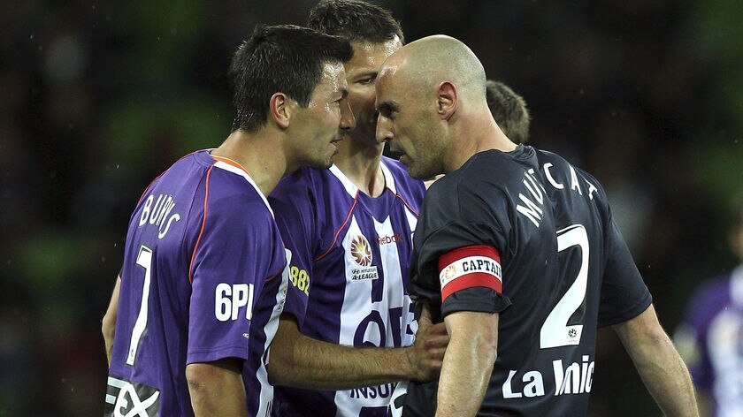 Handbags: Kevin Muscat and Jacob Burns have a disagreement in Perth's 2-0 defeat of Melbourne.