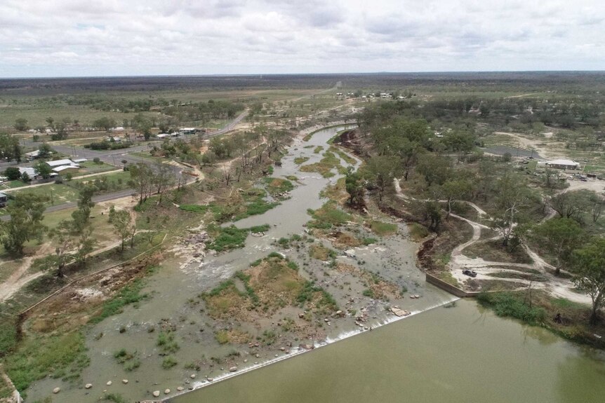 An image from the air which shows a semi-full river, a small town and a lot of bush and scrub
