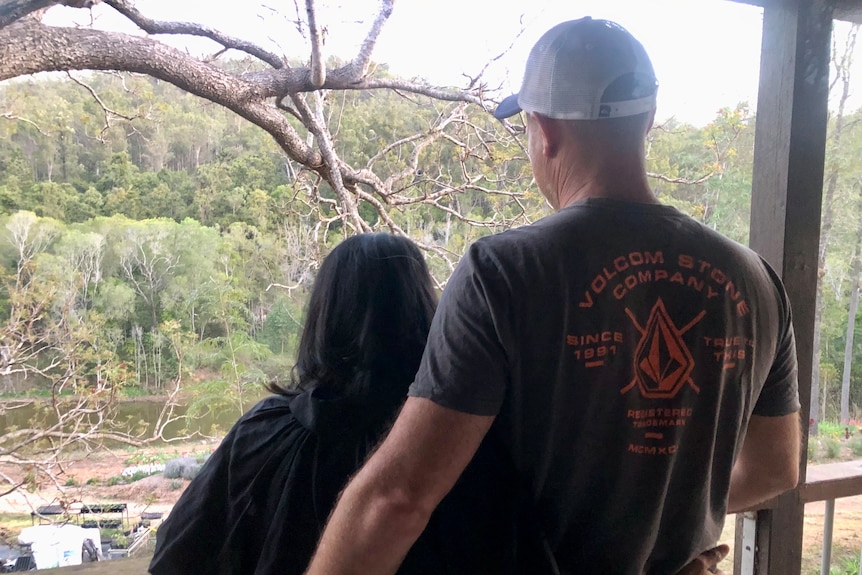 Couple looking out from their deck