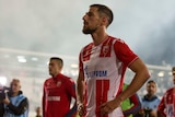 Milos Degenek stands with his hands on his hips