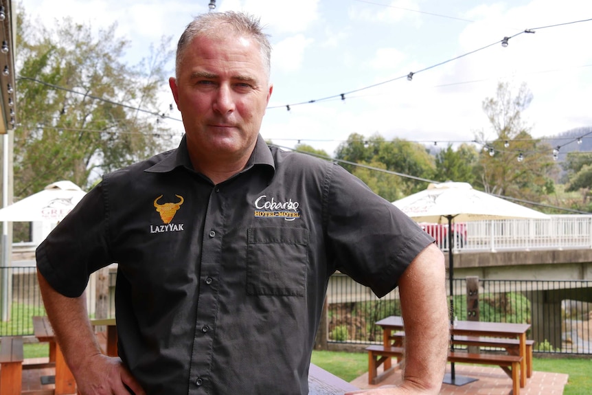 man standing in an outdoor dining area