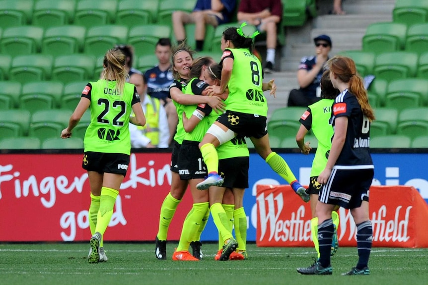 Canberra United players congratulate Ashleigh Sykes for her W-League goal against Melbourne Victory.