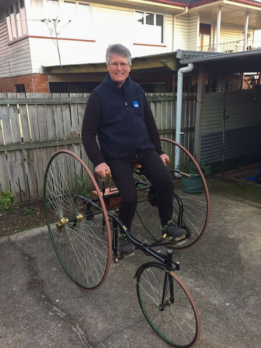 Brett Richardson sits up on his Penny Farthing.