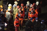 Rescue workers carry a body out of the collapsed Turkey coalmine