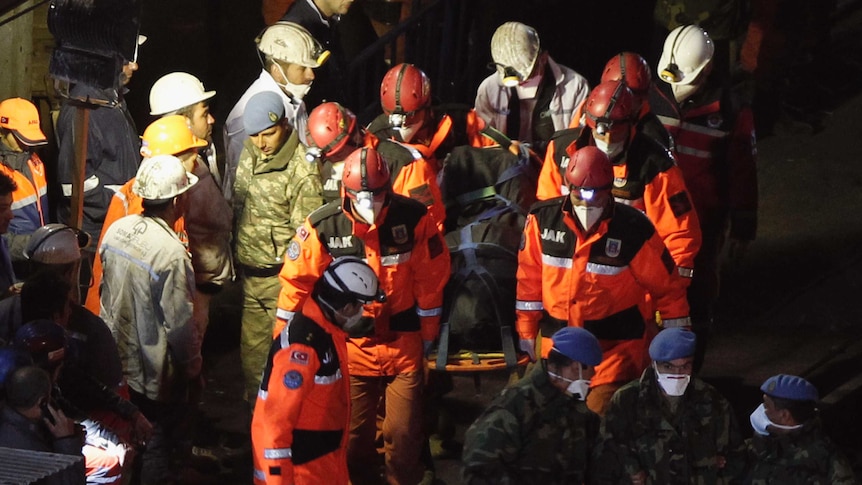 Rescue workers carry a body out of the collapsed Turkey coalmine