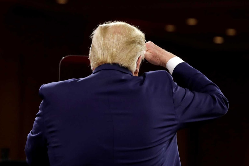 US President Donald Trump looks at the audience